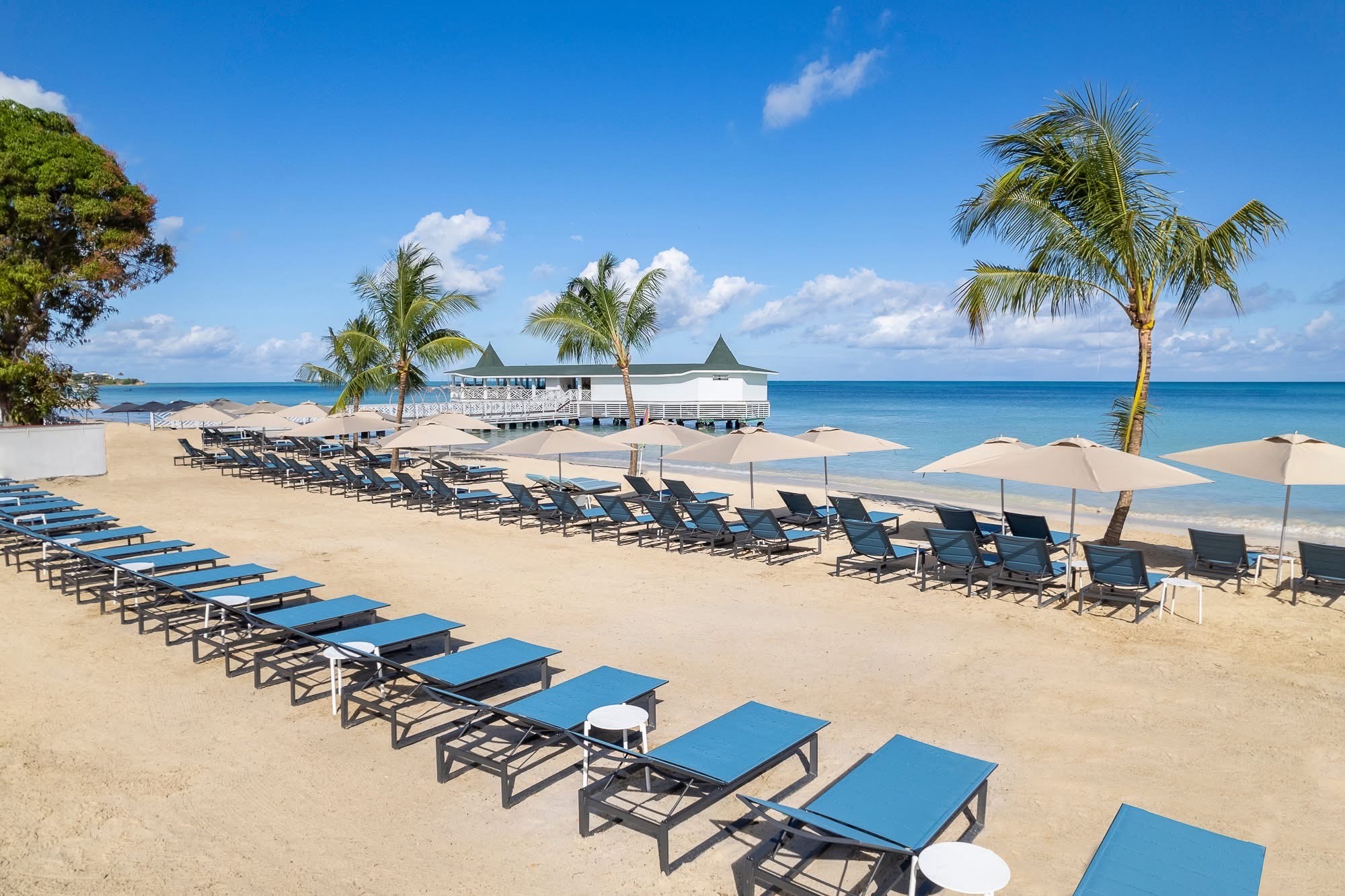 Rows of loungers and umbrellas along a Caribbean beach